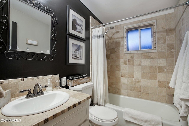 full bathroom featuring toilet, shower / tub combo with curtain, and sink