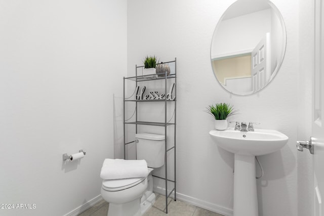 bathroom with tile patterned floors, toilet, and sink