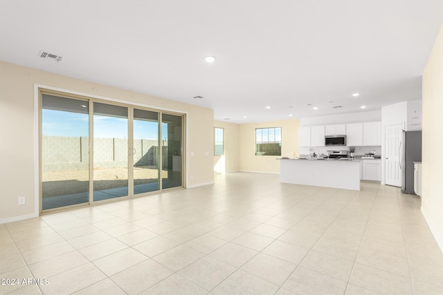 unfurnished living room featuring light tile patterned floors