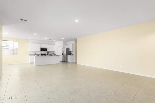 unfurnished living room featuring light tile patterned flooring