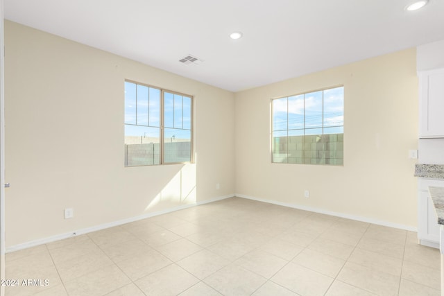 unfurnished room featuring light tile patterned floors