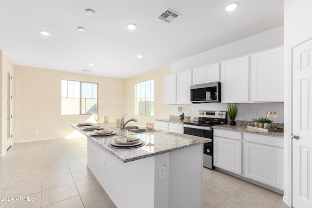 kitchen featuring sink, white cabinetry, a kitchen island with sink, and appliances with stainless steel finishes