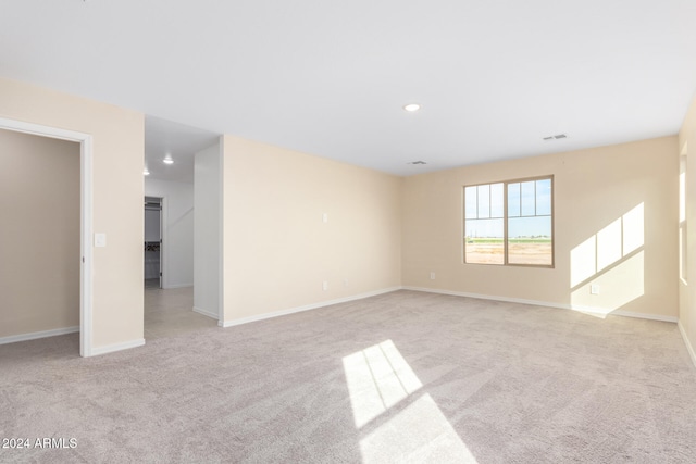 unfurnished room featuring light colored carpet