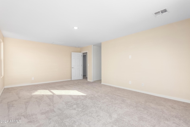 spare room with light colored carpet