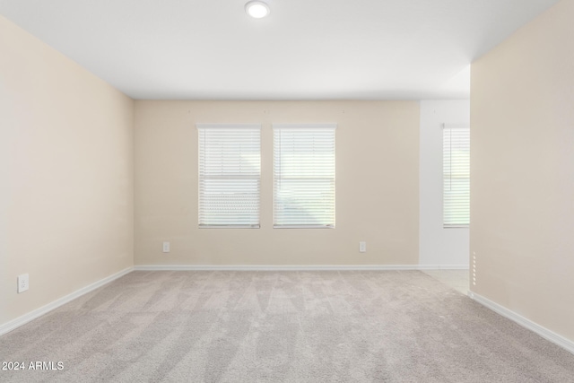 carpeted spare room with plenty of natural light