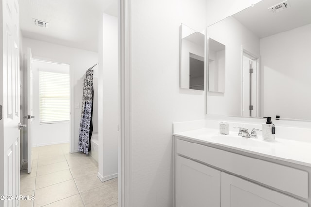 bathroom featuring shower / bath combo, vanity, and tile patterned floors