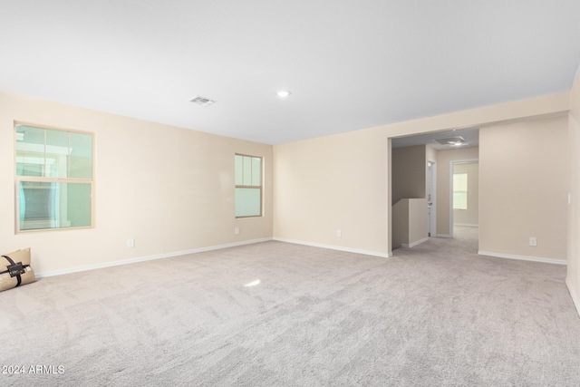 unfurnished room featuring light carpet