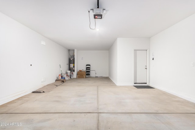 garage with strapped water heater and a garage door opener