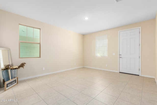 unfurnished room featuring light tile patterned floors