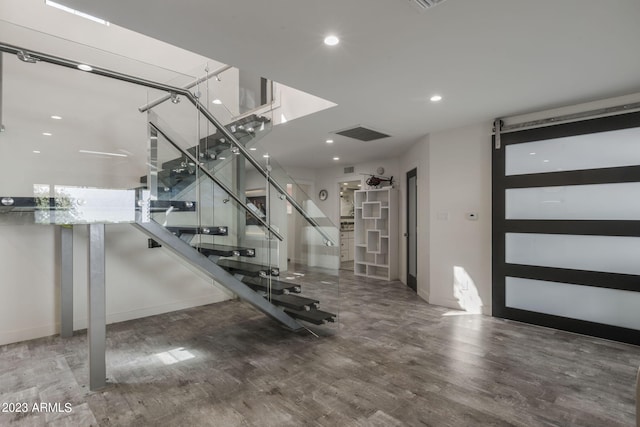 interior space with hardwood / wood-style floors and a barn door