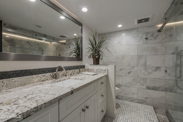 bathroom featuring vanity, toilet, and walk in shower