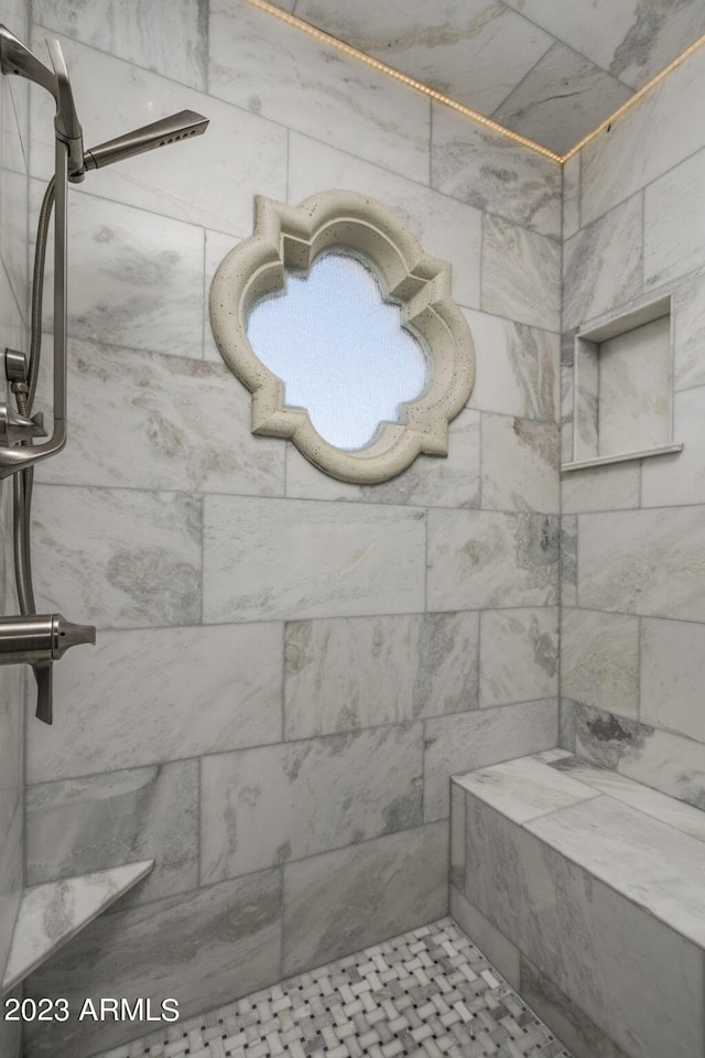 bathroom with a tile shower