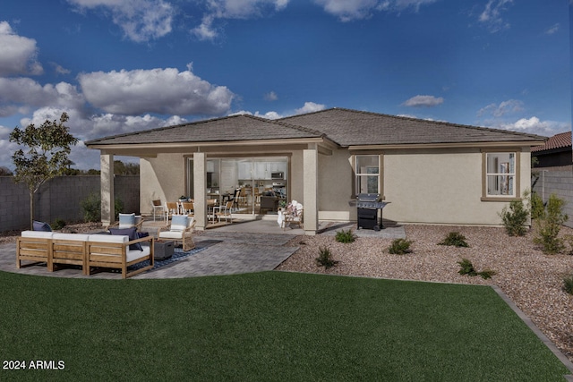 back of house with an outdoor living space, a yard, and a patio