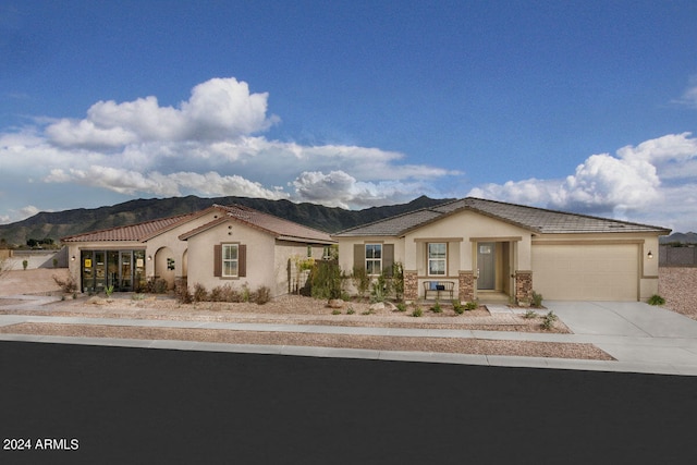 view of front of property featuring a mountain view and a garage