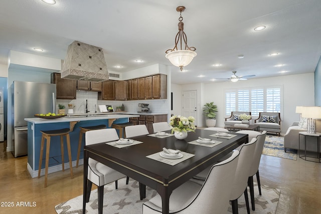 8713 E Sage Dr, Scottsdale, AZ 85250 - dining space featuring recessed lighting, estacked washer and dryer, finished concrete floors, and a ceiling fan