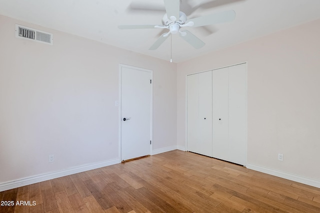 8713 E Sage Dr, Scottsdale, AZ 85250 - unfurnished bedroom with wood finished floors, baseboards, a closet, and a ceiling fan