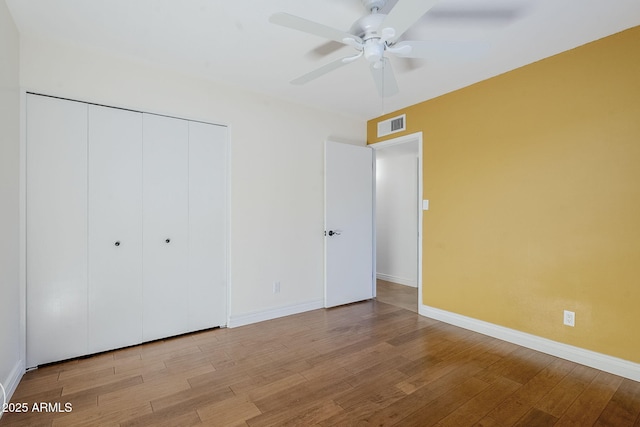 8713 E Sage Dr, Scottsdale, AZ 85250 - unfurnished bedroom featuring wood finished floors, baseboards, a closet, and a ceiling fan