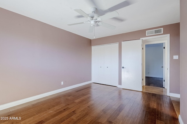 8713 E Sage Dr, Scottsdale, AZ 85250 - unfurnished bedroom with wood finished floors, baseboards, a closet, and ceiling fan