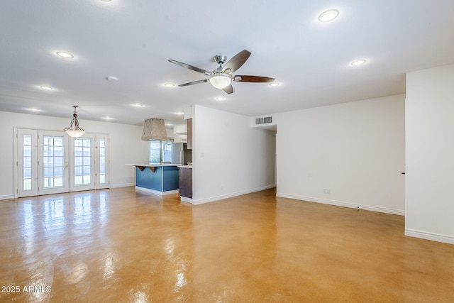 8713 E Sage Dr, Scottsdale, AZ 85250 - unfurnished living room with baseboards, finished concrete floors, ceiling fan, and recessed lighting