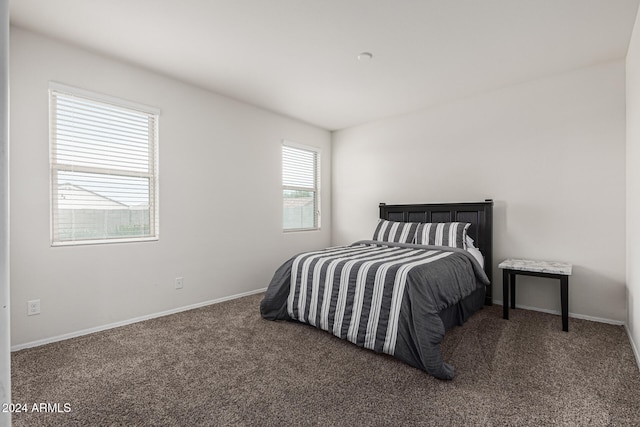 bedroom with dark carpet