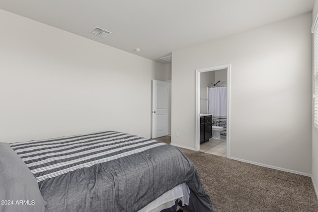 carpeted bedroom featuring connected bathroom