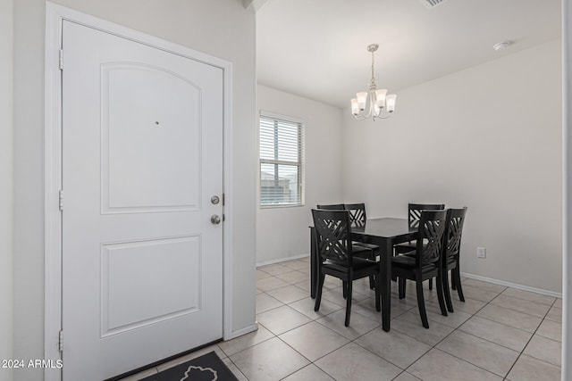 dining room featuring an inviting chandelier and light tile patterned floors