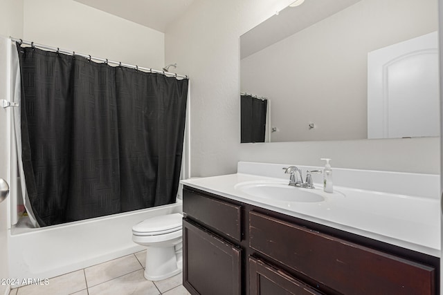 full bathroom with shower / tub combo with curtain, tile patterned flooring, vanity, and toilet