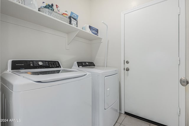 laundry area with light tile patterned flooring and separate washer and dryer