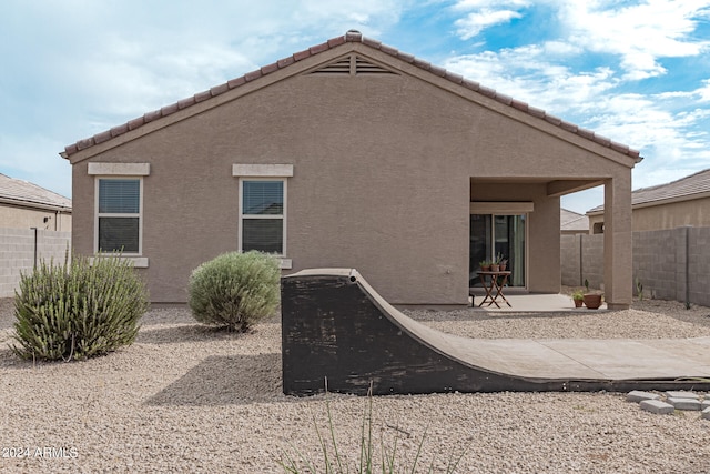 rear view of property featuring a patio