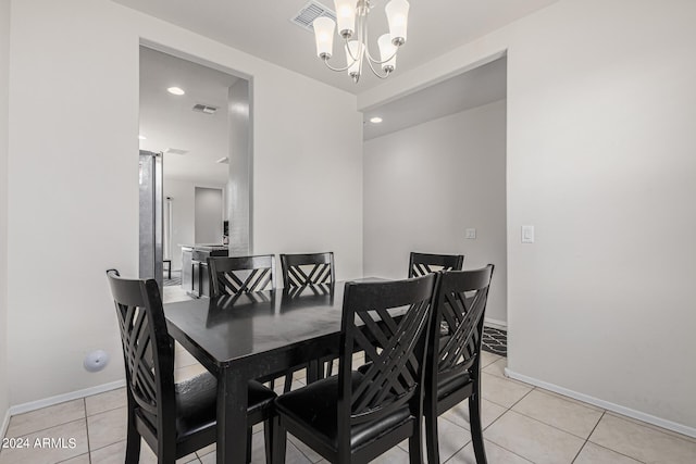 dining area with an inviting chandelier and light tile patterned floors