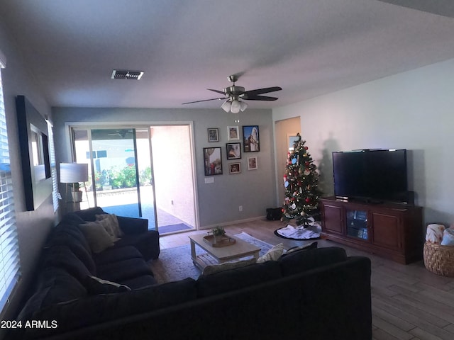 living room featuring light hardwood / wood-style flooring and ceiling fan