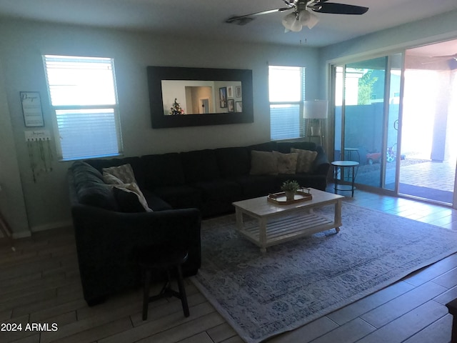 living room featuring ceiling fan and hardwood / wood-style floors