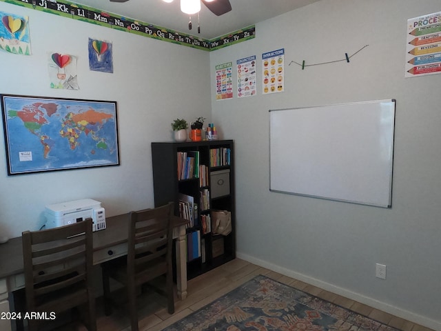 home office with wood-type flooring and ceiling fan