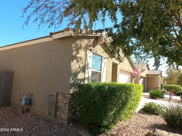 view of side of home with a garage