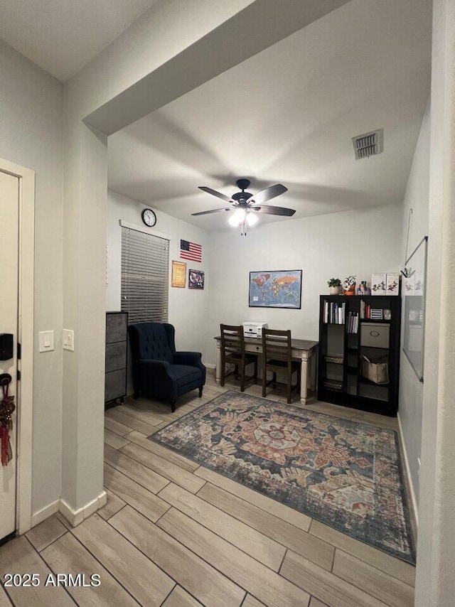 interior space with ceiling fan