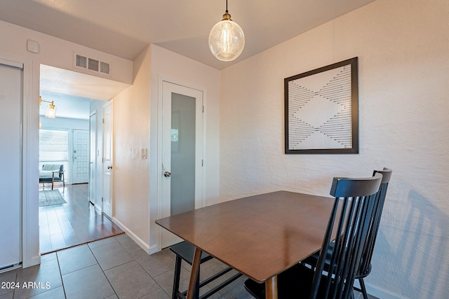 dining space with wood-type flooring