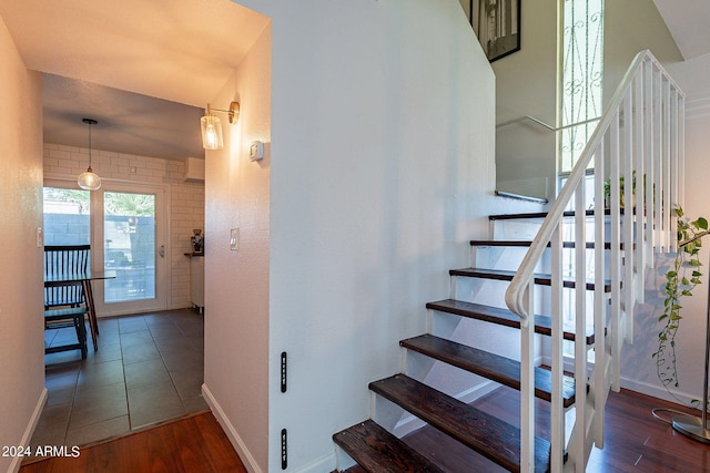 stairs featuring hardwood / wood-style floors