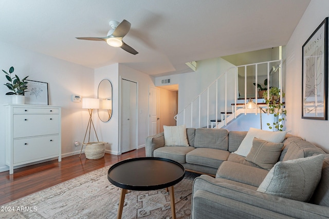 living room featuring wood-type flooring and ceiling fan