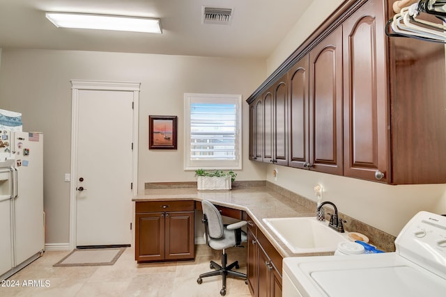 washroom featuring cabinets, sink, washer / dryer, and light tile floors