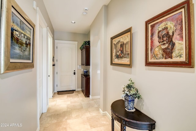 hall featuring light tile flooring