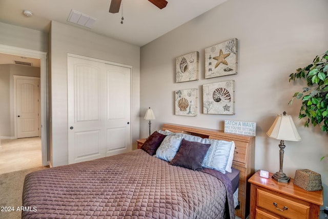 carpeted bedroom featuring a closet and ceiling fan