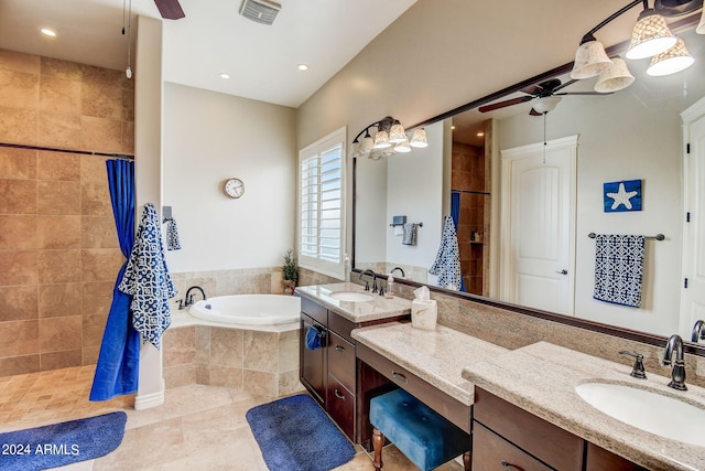 bathroom featuring ceiling fan, tile floors, vanity, and tiled tub