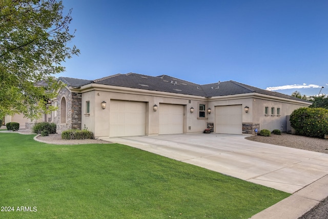 prairie-style home with a front yard and a garage