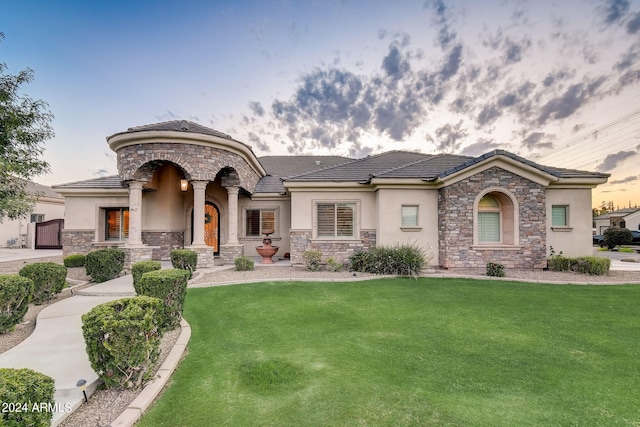 view of front of property with a yard