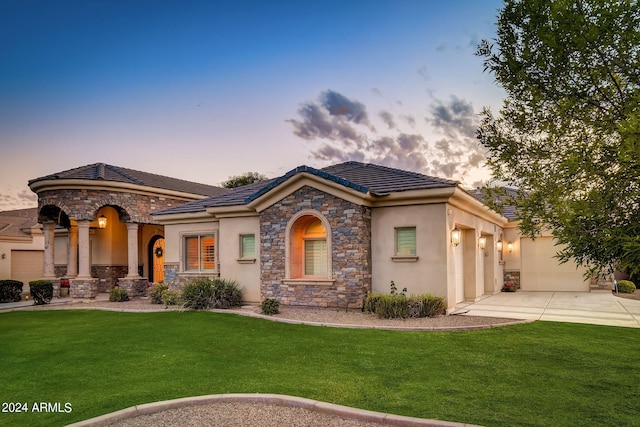 view of front of home with a lawn and a garage