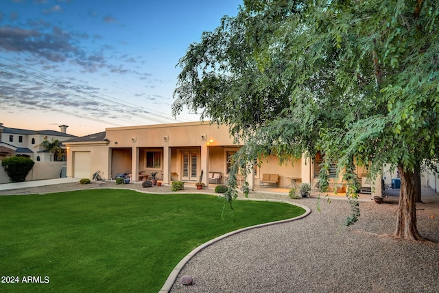 view of front of property featuring a lawn and a garage