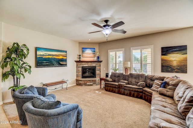 living room featuring light colored carpet, a fireplace, and ceiling fan