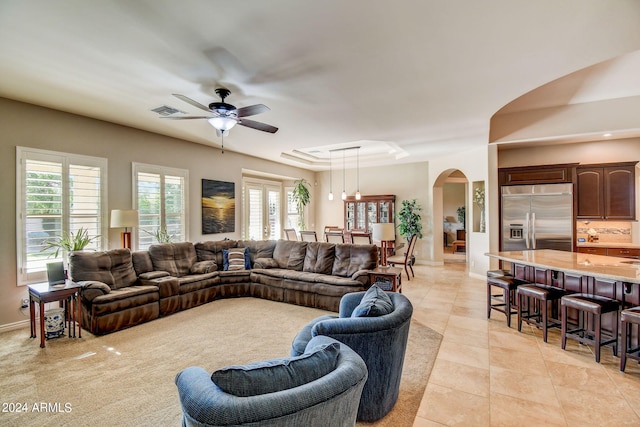 living room with plenty of natural light, ceiling fan, and light tile floors