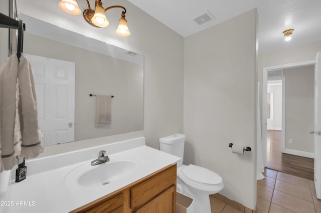 7405 W Elwood St, Phoenix, AZ 85043 - bathroom featuring tile patterned flooring, toilet, vanity, baseboards, and a chandelier