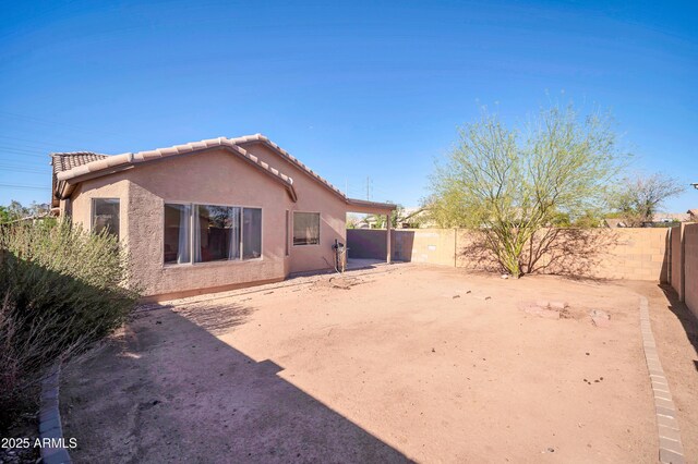 7405 W Elwood St, Phoenix, AZ 85043 - rear view of house featuring a tile roof, a fenced backyard, and stucco siding
